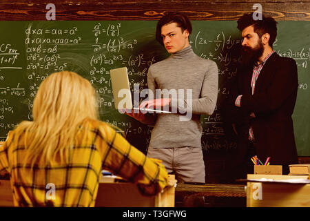 University studying friends studying and reading a books in classroom. Teachers reputation is gold. Students build positive relationships with their Stock Photo