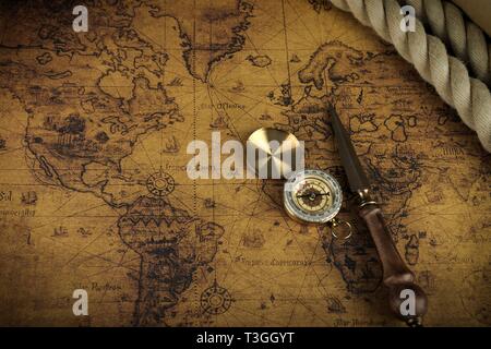 Vintage Compass lies on an ancient world map - adventure stories background Stock Photo