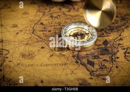 Vintage compass lies on an ancient world map Stock Photo - Alamy