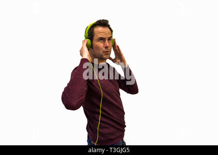 Man listening to music on white background Stock Photo