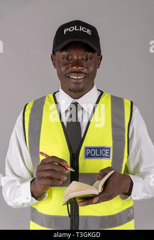 Police inspector in uniform with cap and revolver and stick in hand on ...