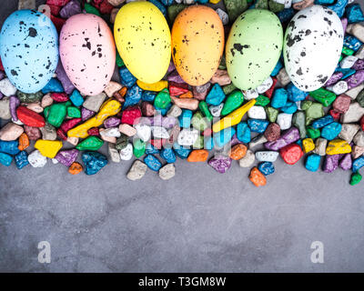 Easter composition Colorful Easter Egg background with sweet candy Top view with copy space Stock Photo