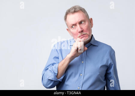 an thinking about his problems, expressing some doubts Stock Photo