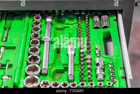 set of wrenches in a plastic stand in a drawer of a nightstand in a car repair shop Stock Photo
