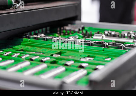 set of wrenches in a plastic stand in a drawer of a nightstand in a car repair shop Stock Photo