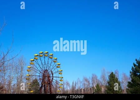 Ferris wheel in the ghost town of Pripyat inside the exclusion zone of Chernobyl, Ukraine, April 2019. Once a model town in the Soviet Union, Pripyat  Stock Photo
