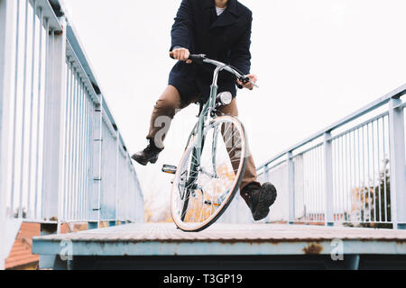 Casual dressed man cycling around Stock Photo