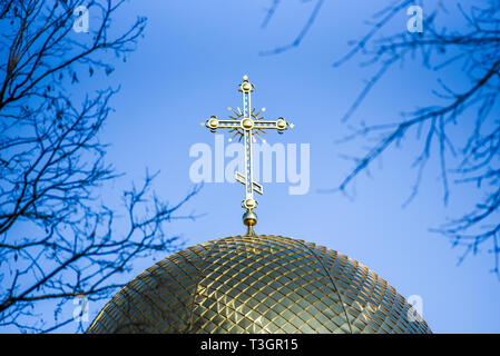 Golden orthodox cross on the dome of the church. Stock Photo