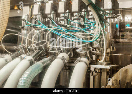 unit for pouring yoghurt into plastic jars at a dairy factory Stock Photo