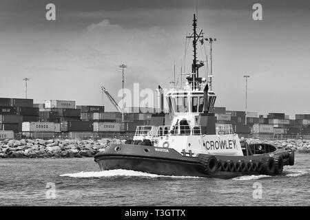 Black And White Photo Of A Crowley Maritime Tractor Tug, MASTER, Underway In The Port Of Long Beach, California, USA. Stock Photo