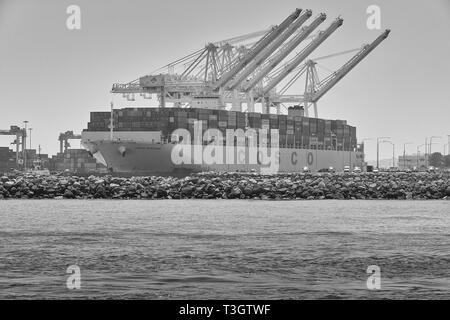 Black And White Photo Of The Giant COSCO SHIPPING Container Ship, COSCO PORTUGAL, Moored In The Long Beach Container Terminal, California, USA Stock Photo