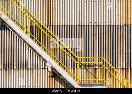 exterior of metal sheet warehouse wall and fire exit stair Stock Photo