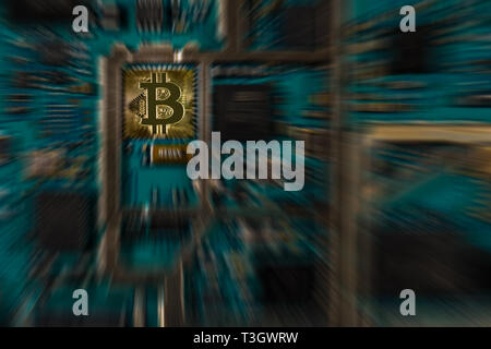 Bitcoin digital currency on electronic print circuit board with zooming effect - conceptual Stock Photo