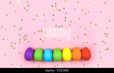 Colored Easter eggs on pink background. Flatlay. Stock Photo
