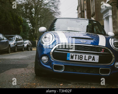 A blue mini cooper on a road in Bath, UK Stock Photo