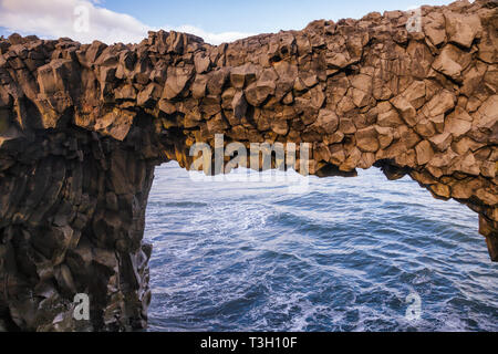 Natural basalt arch at Dyrholaey promontory near the village of Vik i Myrdal, a popular tourist attraction on the South Coast of Iceland, Scandinavia Stock Photo