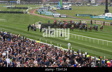 Action during the Randox Health Topham Handicap Chase as racegoers look on during Ladies Day of the 2019 Randox Health Grand National Festival at Aintree Racecourse. Stock Photo