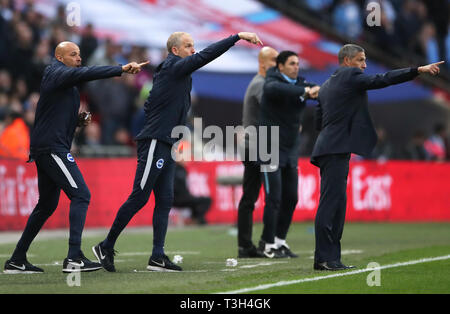 Brighton & Hove Albion first team coach Paul Nevin (left), assistant manager Paul Trollope and manager Chris Hughton (right) during the FA Cup semi final match at Wembley Stadium, London. Stock Photo