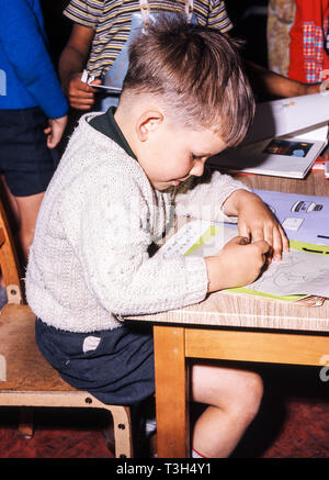 Junior age child working in the school classroom Stock Photo