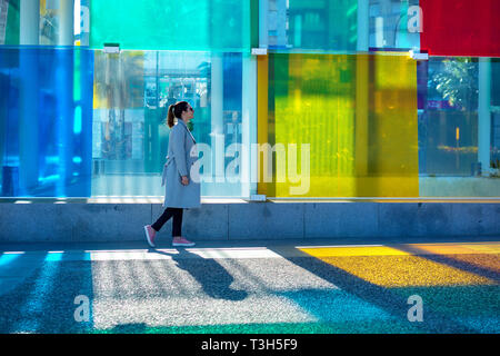 Spain, Malaga - 04.04.2019: Woman walking next to the colorful cube Centre Pompidou in Malaga, Spain in sunshine Stock Photo