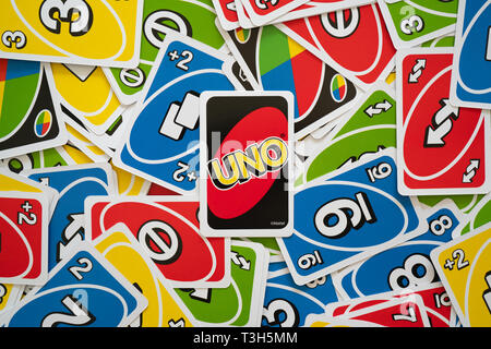 6 April 2019, Wuhan China : Uno game cards scattered all over the frame and one card showing the reverse side with Uno logo in the middle Stock Photo