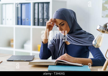Female Muslim student concentrated Stock Photo