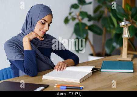 Arabian woman reading a book Stock Photo