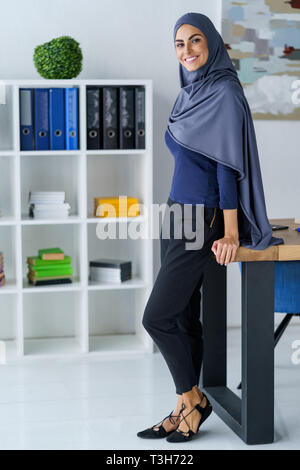 Smiling Muslim woman standing Stock Photo