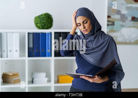 Frustrated female office worker Stock Photo
