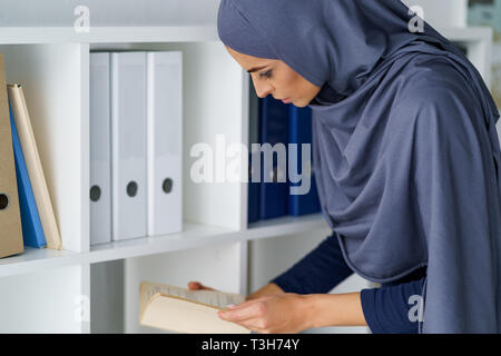 Arabian woman reading a book Stock Photo