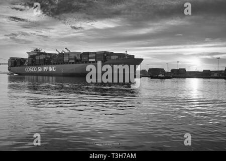 Moody Black And White Photo Of The COSCO SHIPPING Container Ship, CSCL SPRING Departing The Port of Los Angeles, California, USA. Stock Photo