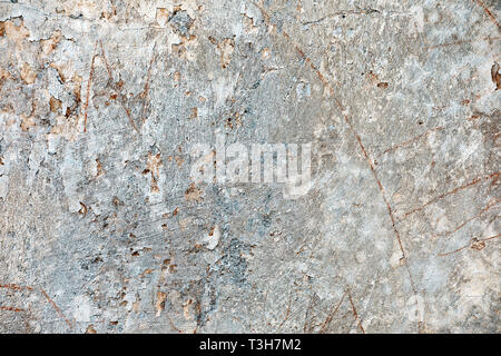 Close up textured surface of weathered concrete cement wall with cracks for backdrop background use Stock Photo