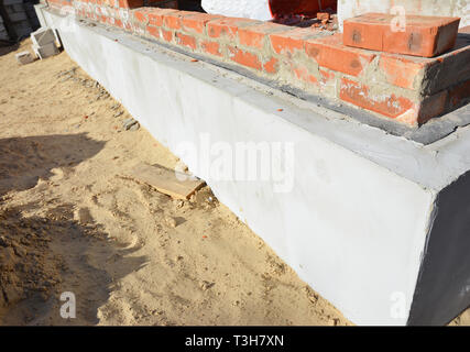House foundation wall insulation, plastering, damp proofing, waterproofing. Stock Photo