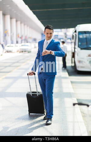 Detail of a businessman pulling a trolley in an airport Stock Photo