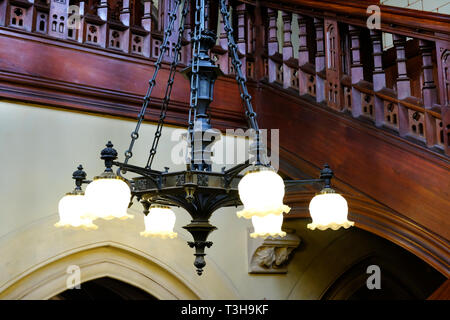 Close-up of a wooden, gothic style electric chandelier - John Gollop Stock Photo