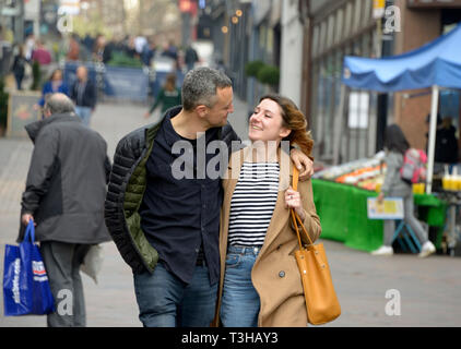Couple walking, looking at each other. Stock Photo
