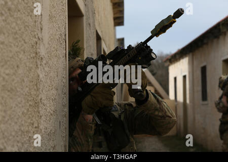 A British soldier of Charlie Company, Prince of Wales’s Royal Regiment, scans a rooftop during exercise Allied Spirit X in Hohenfels, Germany, April 4, 2019. Exercise Allied Spirit X includes approximately 5,600 participants from 15 nations, March 30-April 17, 2019, at the 7th Army Training Command's Hohenfels Training Area in Southeastern Germany. Allied Spirit is a U.S. Army Europe-directed, 7th Army Training Command-conducted multinational exercise series designed to develop and enhance NATO and key partner interoperability and readiness across specified warfighting functions. (U.S. Army ph Stock Photo