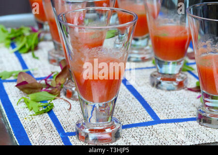Gazpacho soup in glasses on blue and white tablecloth Stock Photo