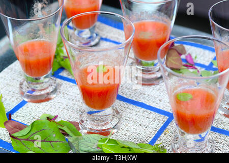 Gazpacho soup in glasses on blue and white tablecloth Stock Photo