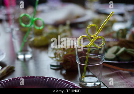 Celebration on the way, a kids birthday party with straws already placed in glasses Stock Photo