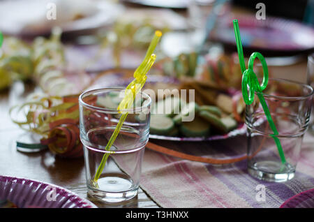 Celebration on the way, a kids birthday party with straws already placed in glasses Stock Photo