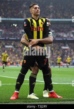 Watford's Gerard Deulofeu celebrates scoring his side's third goal of the game with Troy Deeney (right) during the FA Cup semi final match at Wembley Stadium, London. Stock Photo