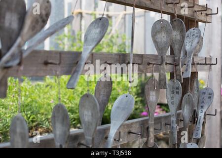 Wooden ema (prayer tablets) hanging in a shrine in a park in Sakai City, Osaka, Japan. Stock Photo