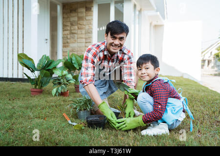 father and son gardening at home in the morning Stock Photo