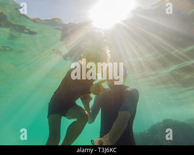 Underwater portrait of father and son snorkeling together Stock Photo