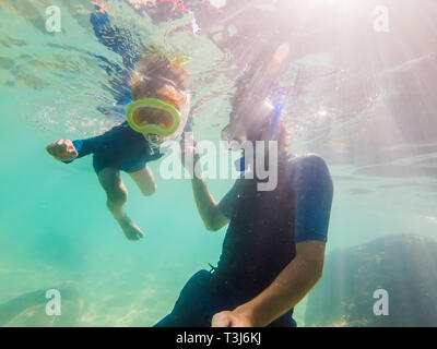 Underwater portrait of father and son snorkeling together Stock Photo