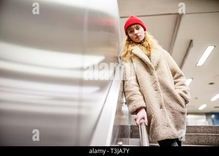 Girl, teenager, standing at the stairs of a subway station, Cologne, North Rhine-Westphalia, Germany Stock Photo