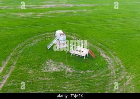 A tank with methanol near the oil well. Equipment of an oil well. Shutoff valves and service equipment. Stock Photo