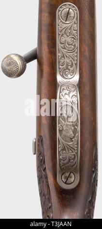 A splendid repeating rifle Mauser 66, cal..30-06, no. SG 50637. Mirror-like bore, length 55.5 cm. Telescope lock. Magazine for two cartridges. Set trigger. Masterly tendrilengravings and gold thread inlay on receiver. Gold inlay on front sight. Richly carved full stock made of figured root wood with hog-back stock, Bavarian cheek-piece with double moulding and Kaiser grip. Cap and nose made of buffalo horn. Scope ZF Zeiss Diavari VM 2.5 - 10 x 50 (reticule 4) on frog mount. Total length 99 cm. Weapon and scope in very good quality. Exclusive luxu, Additional-Rights-Clearance-Info-Not-Available Stock Photo