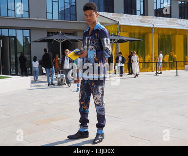 MILAN, ITALY -JUNE 16, 2018:Young man model  posing for photographers after Neil Barrett fashion show, during Milan Fashion Week Stock Photo